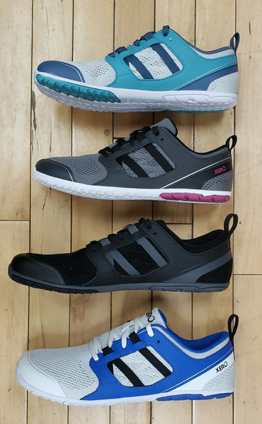 Four Xero Zelen casual work out shoes on their sides, displaying the accent colours on the sole