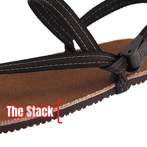 Three quarters close up of an Earth Runners sandal, with a red bracket around the side of the sole. Neon style text reads "The Stack."