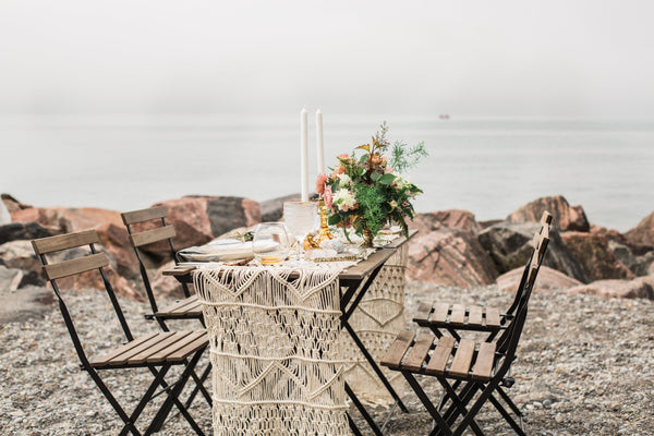 lovely table set for a dinner date on a rocky shore