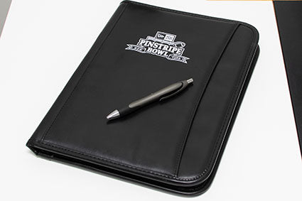 notepad with embroidered logo on a desk