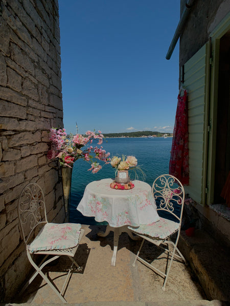 Table and chairs in narrow stairway in Rovinj, Croatia