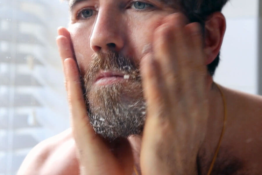 Man washing beard with beard wash