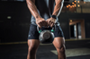 A 16 pound kettlebell in an athlete's hands