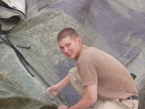 Mitch putting a new roof on a tent in Afghanistan