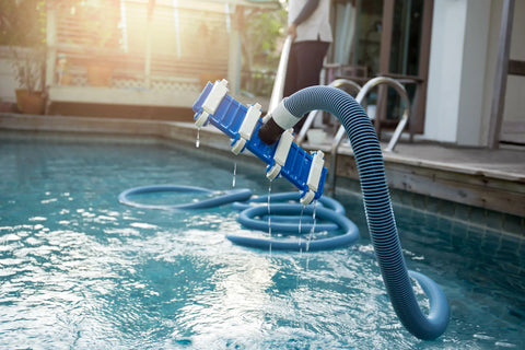 vacuuming a swimming pool