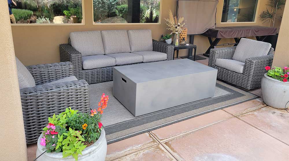 outdoor wicker sofa set with stone fire table