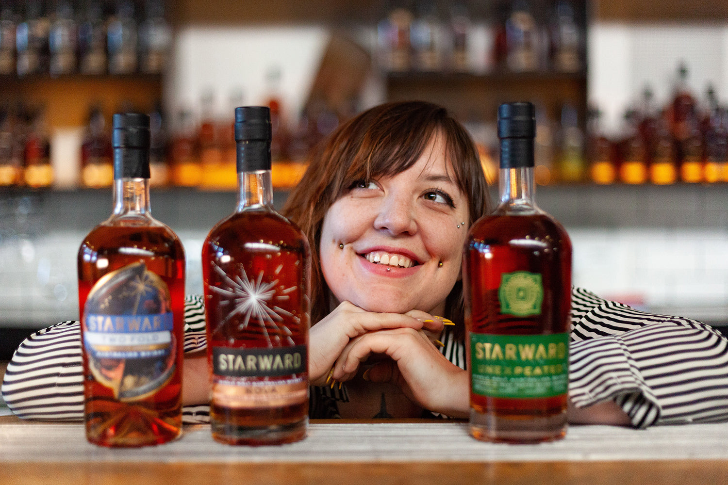 Ally from Starward with the popular whisky bottles smiling