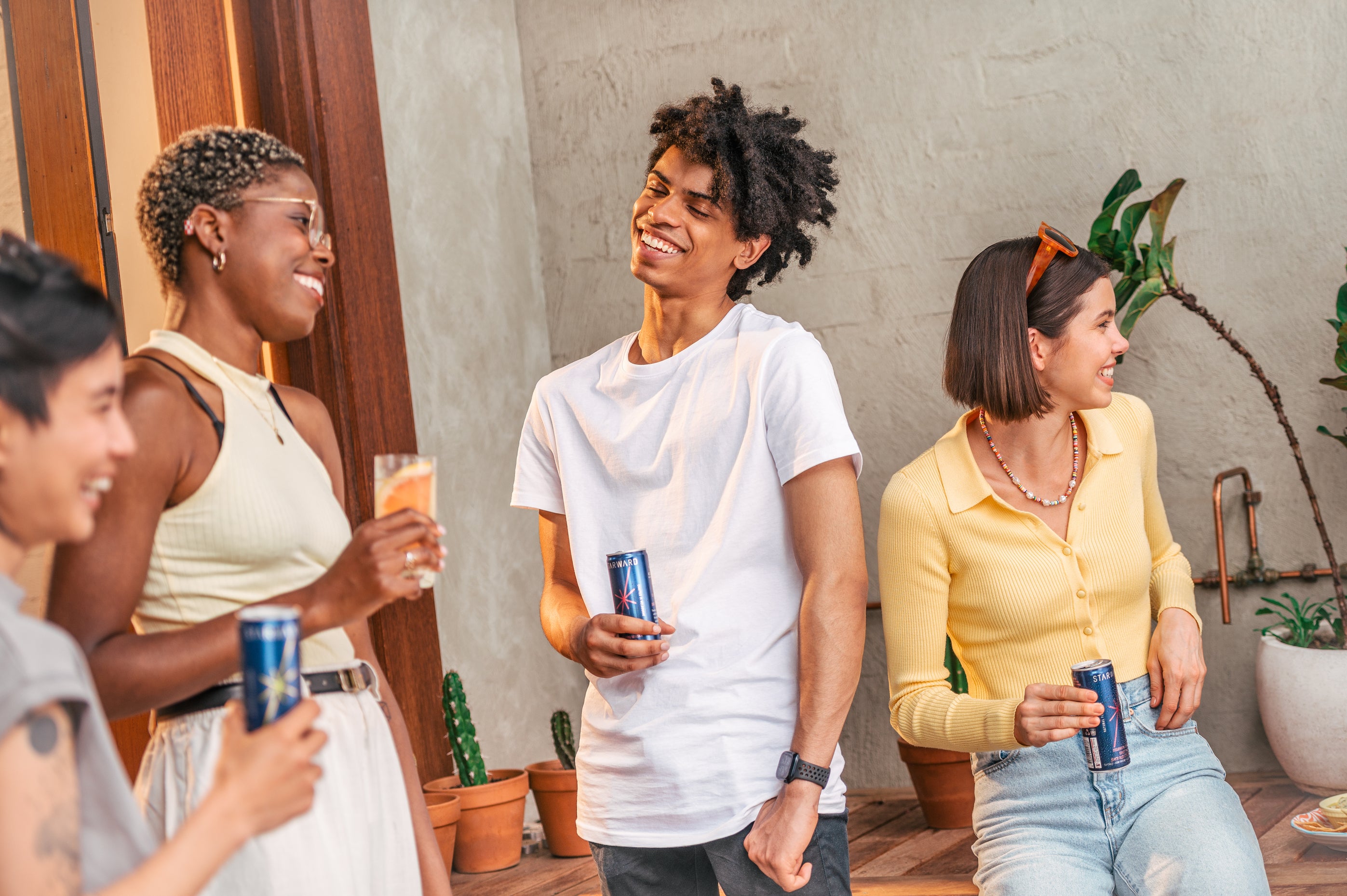 Group of young people having a drink canned cocktails in the backyard, traditional Australian setting D