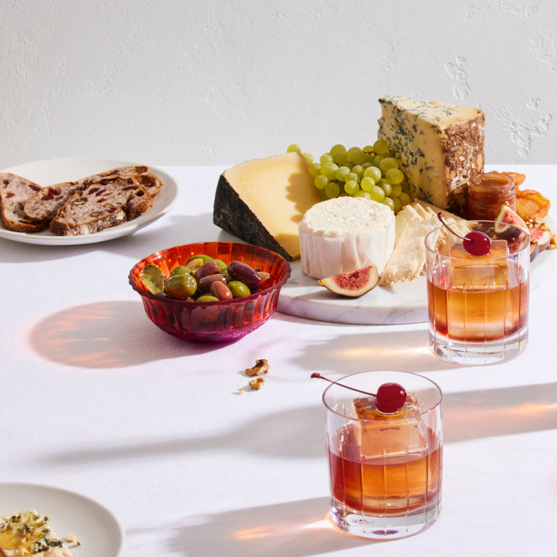 Cheese at a table with whisky cocktails and nibbles