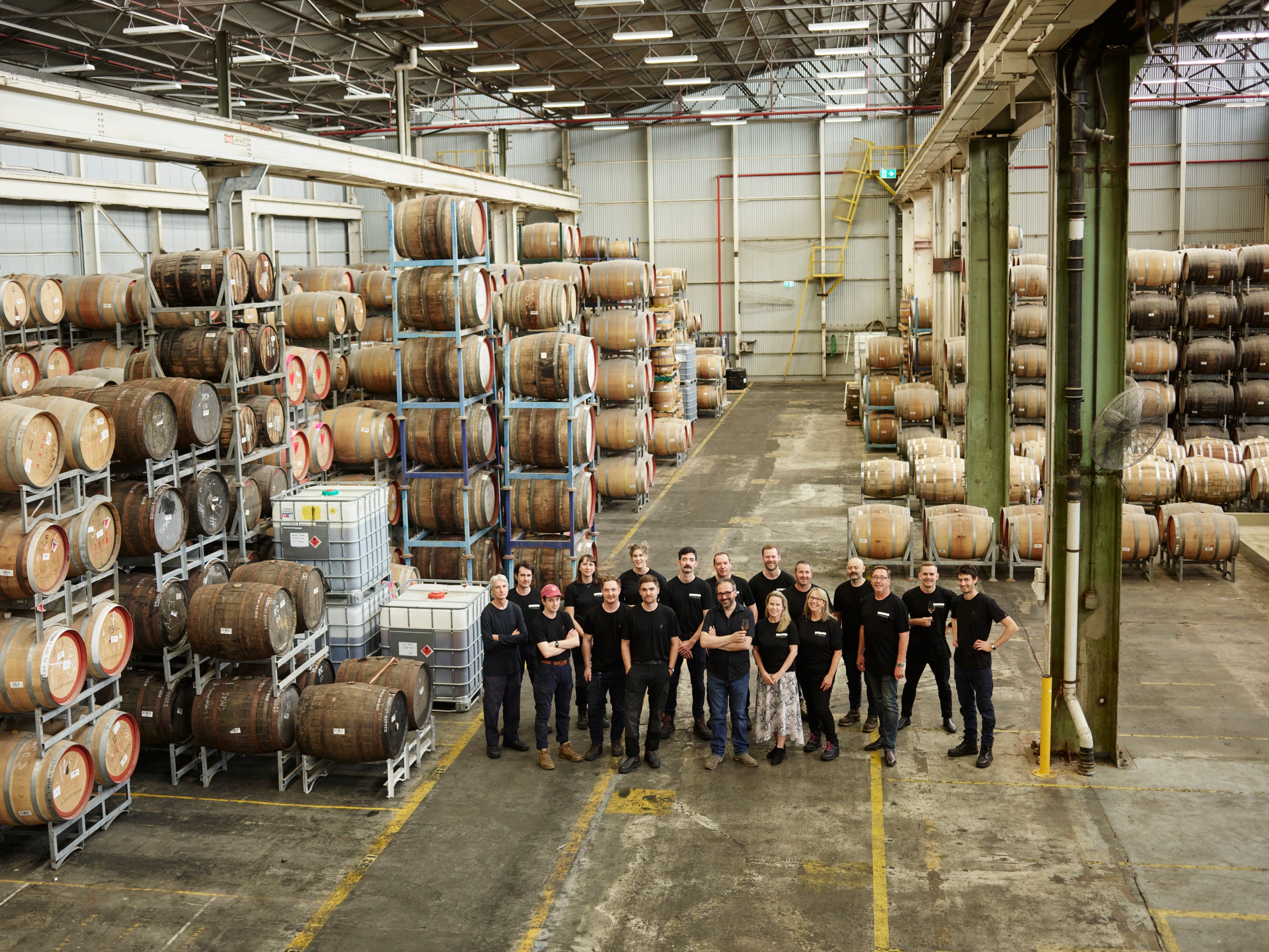 Team photo in the Starward Distillery in Port Melbourne surrounded by whisky barrels