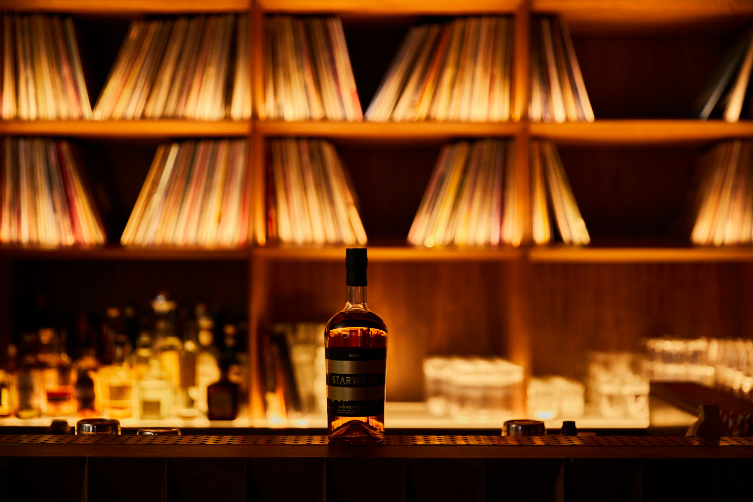 HER Music Room record collection back bar with Honeycomb Whisky in front