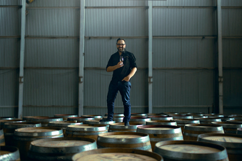 Founder David Vitale standing on barrels at Starward Australian Whisky