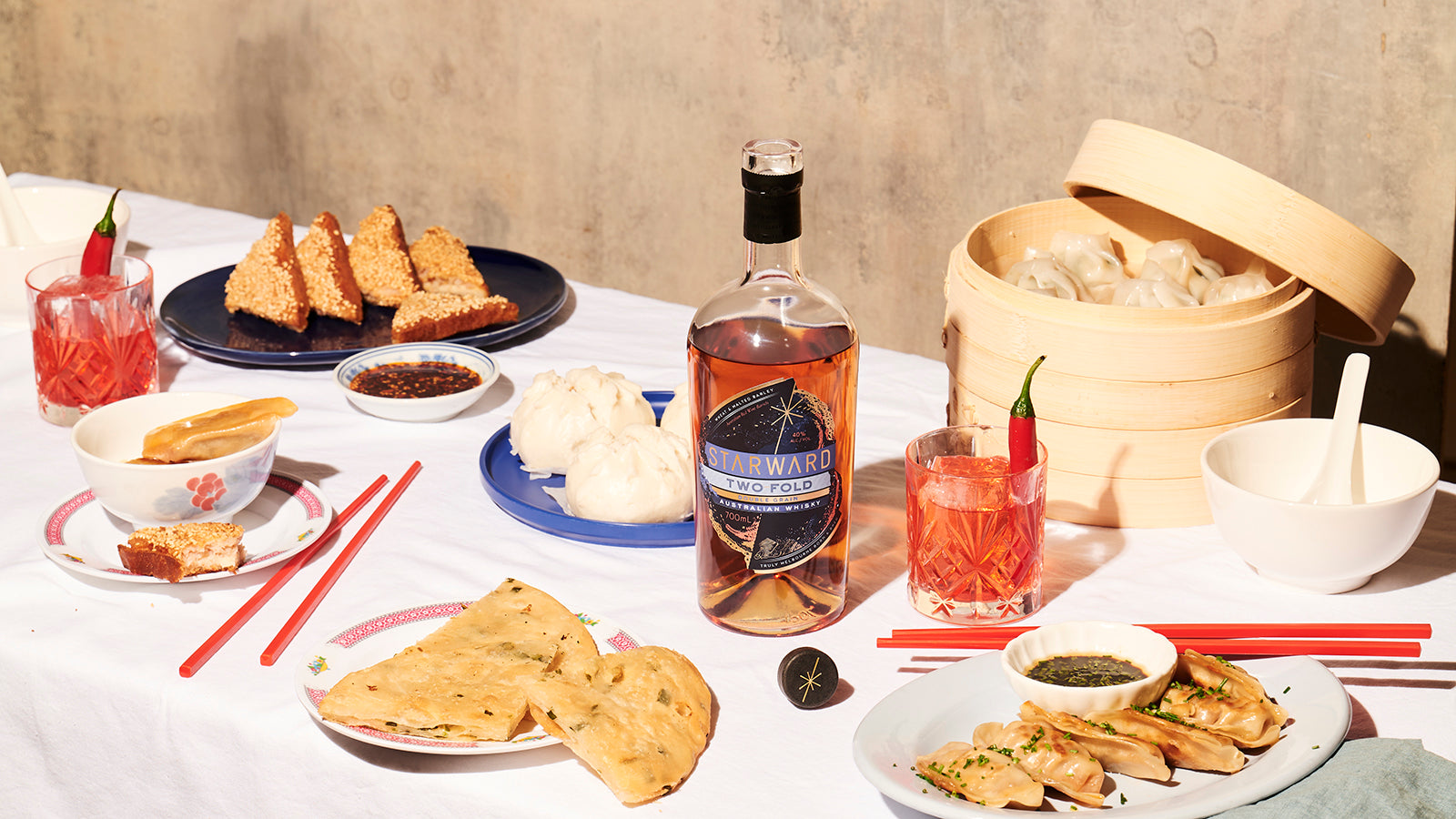 Two-Fold Starward Whisky on a table with the best asian food