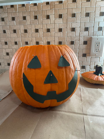 Cut out your stencil and attach it to the pumpkin