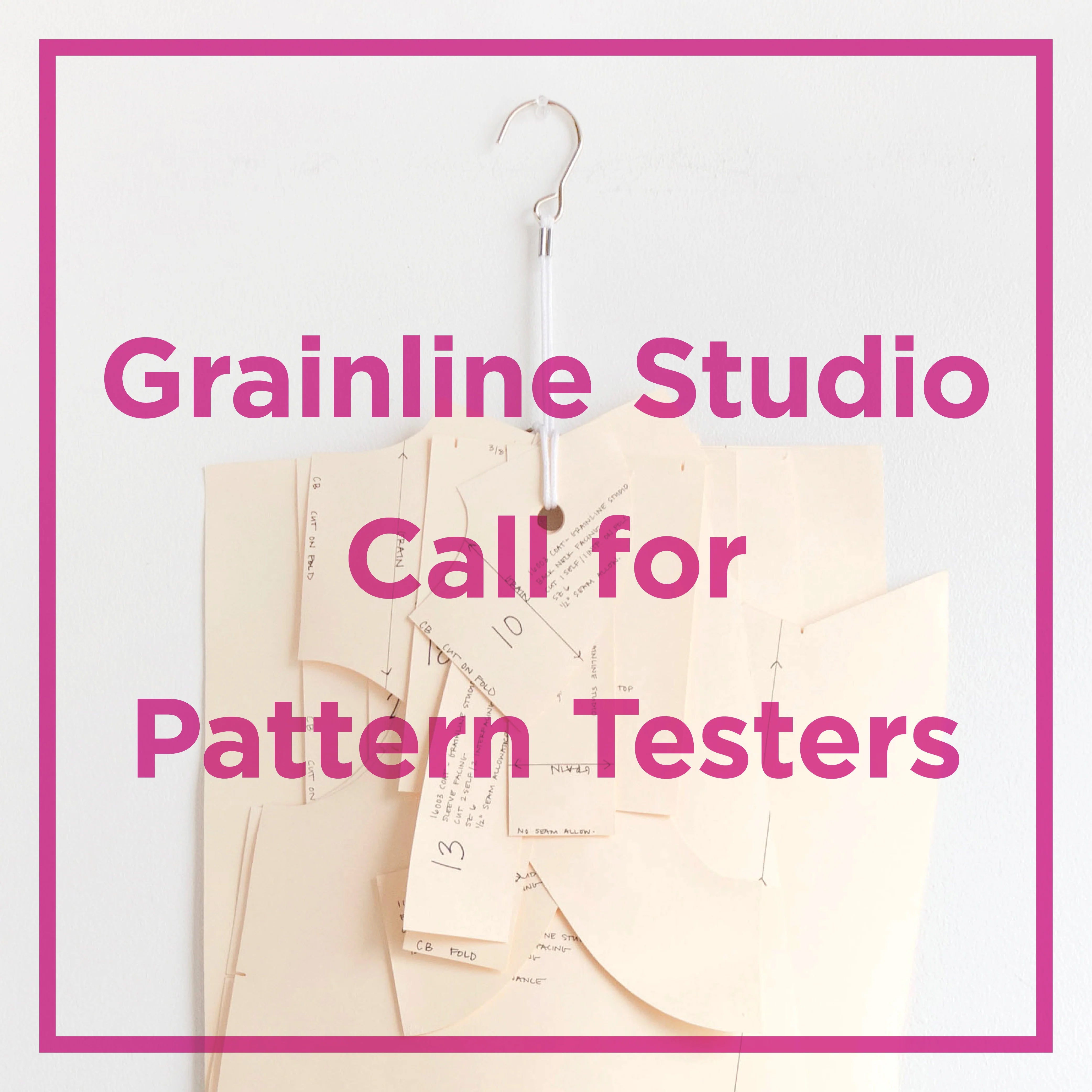 Grainline Studio call for pattern testers 2024. Image is an oaktag pattern hanging on a pattern hook against a white wall. Overtop text says Grainline Studio Call for Pattern Testers in pink.