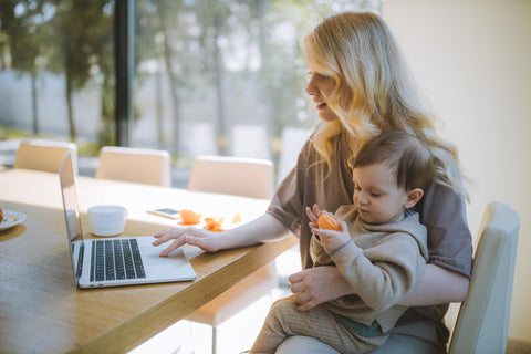 The Mom Store; Blog Post; Working Mom; Working Mother; Photo by Anastasia Shuraeva on Pexels Shuraeva: https://www.pexels.com/photo/woman-carrying-her-baby-and-working-on-a-laptop-4079281/