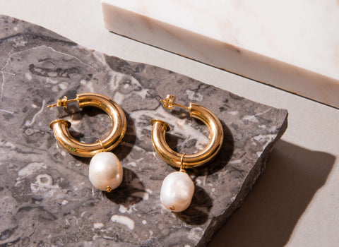 Gold hoop earrings with pearl charms