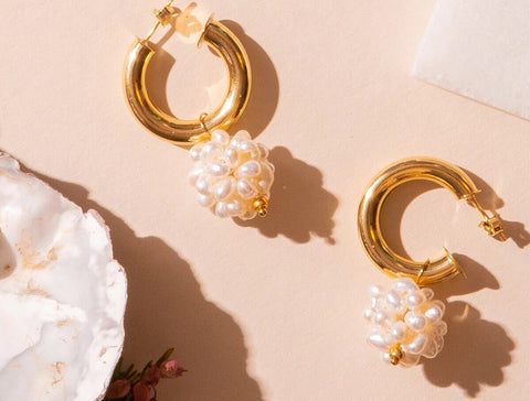 Gold hoop earrings with pearl puff charms