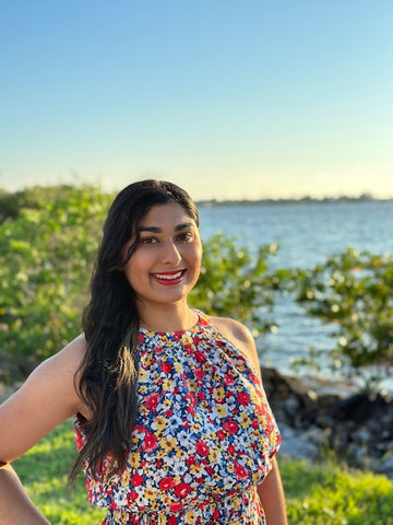 Real People With Dysautonomia: Leaya, an indian woman with POTS wearing a floral print, dark long hair