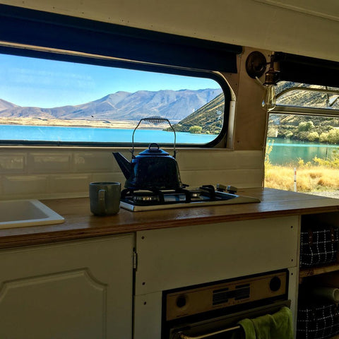 View of a lake in New Zealand from inside an off-grid housebus