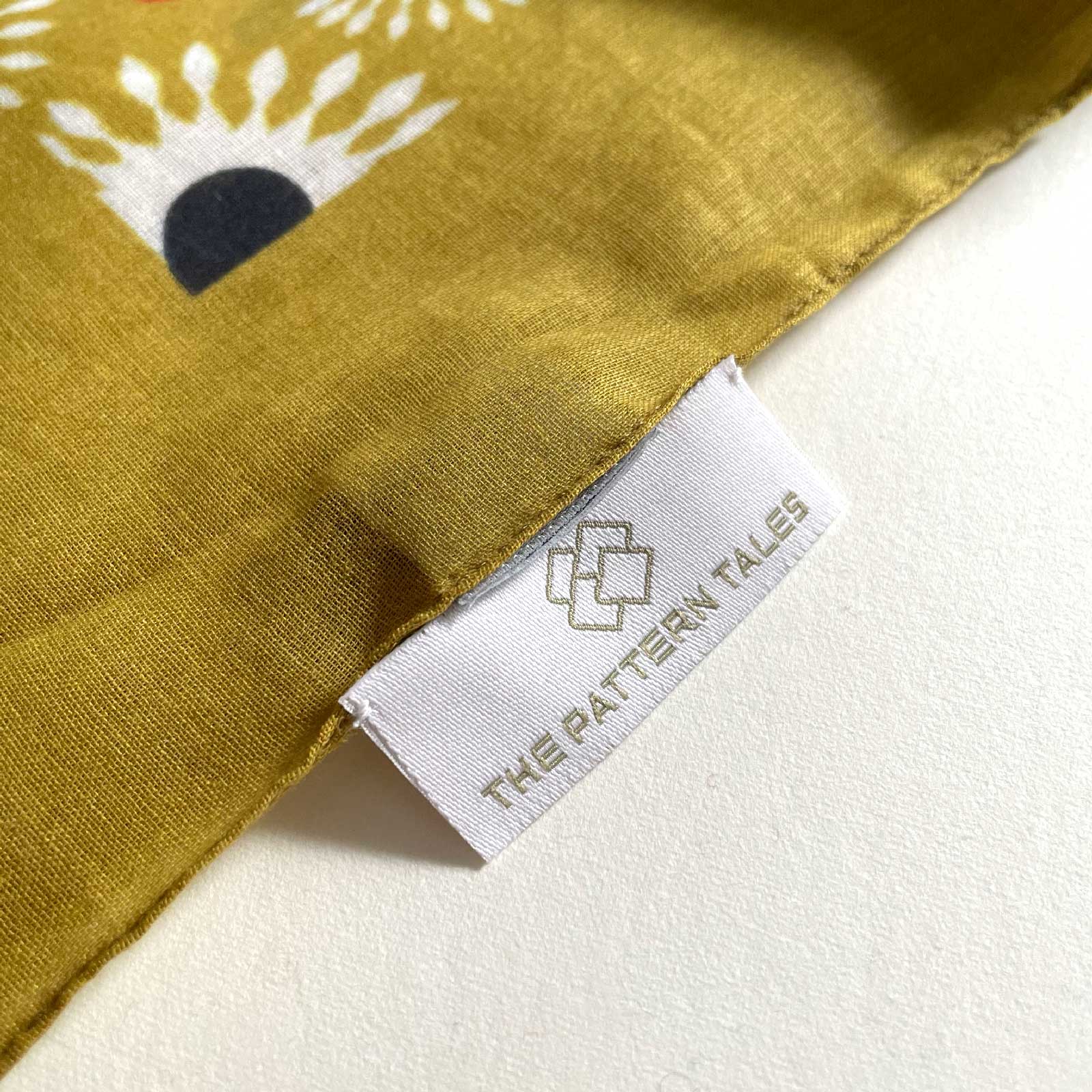 Details scarf Margarita. Hand-stitched label.