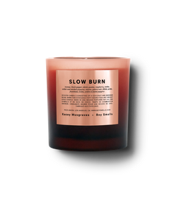 Product shot of Slow burn in a blood red ombre vessel with a peach label and black text against a neutral background.