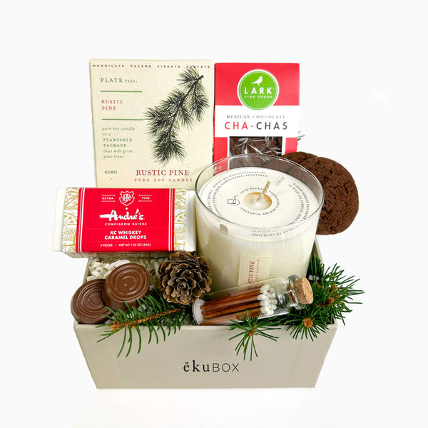 Evergreen Wishes - a sustainable gift box with a plantable candle box. They will enjoy the gift of the candle, whiskey caramel drops, cha cha mexican cookies and they can grow a pine tree.