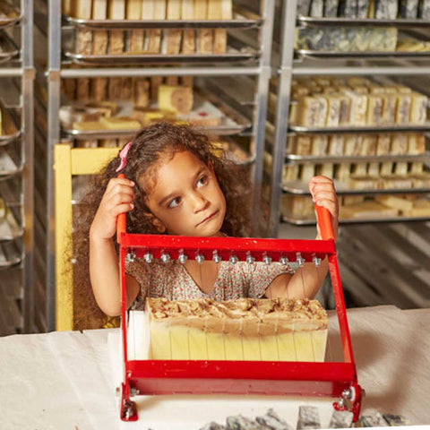 Potager Soap Co. A woman owned and run multi generational company. The owner's granddaughter Miss Eloise is shown cutting the home made soap 