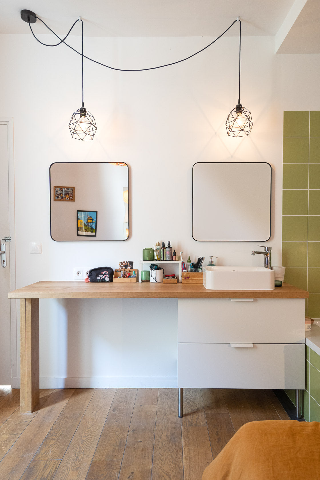 salle de bain moderne et chaleureuse avec double miroir et luminaires suspendus