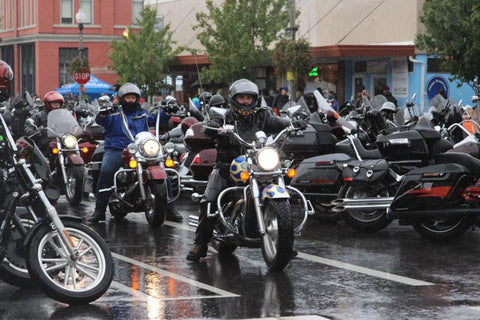 group of motorcycles riding in the rain