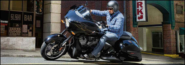 Man riding a victory cross country motorcycle