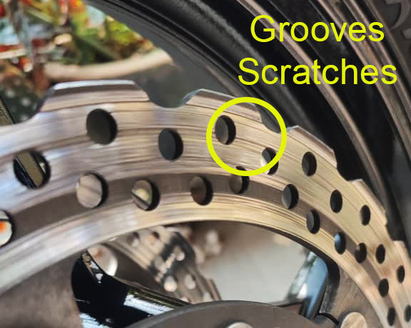 groves and scratches in a motorcycle brake rotor