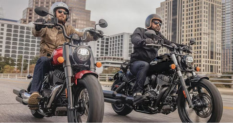 Victory & indian motorcycle riding side by side down the road