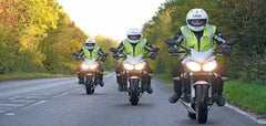 3 motorcycles on the road wearing his visibility vests