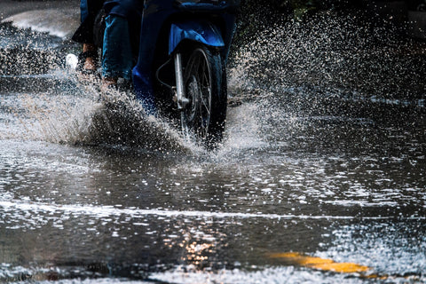 motorcycle riding on the road in the rain