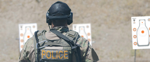 Back of a person in body armor at a firing range