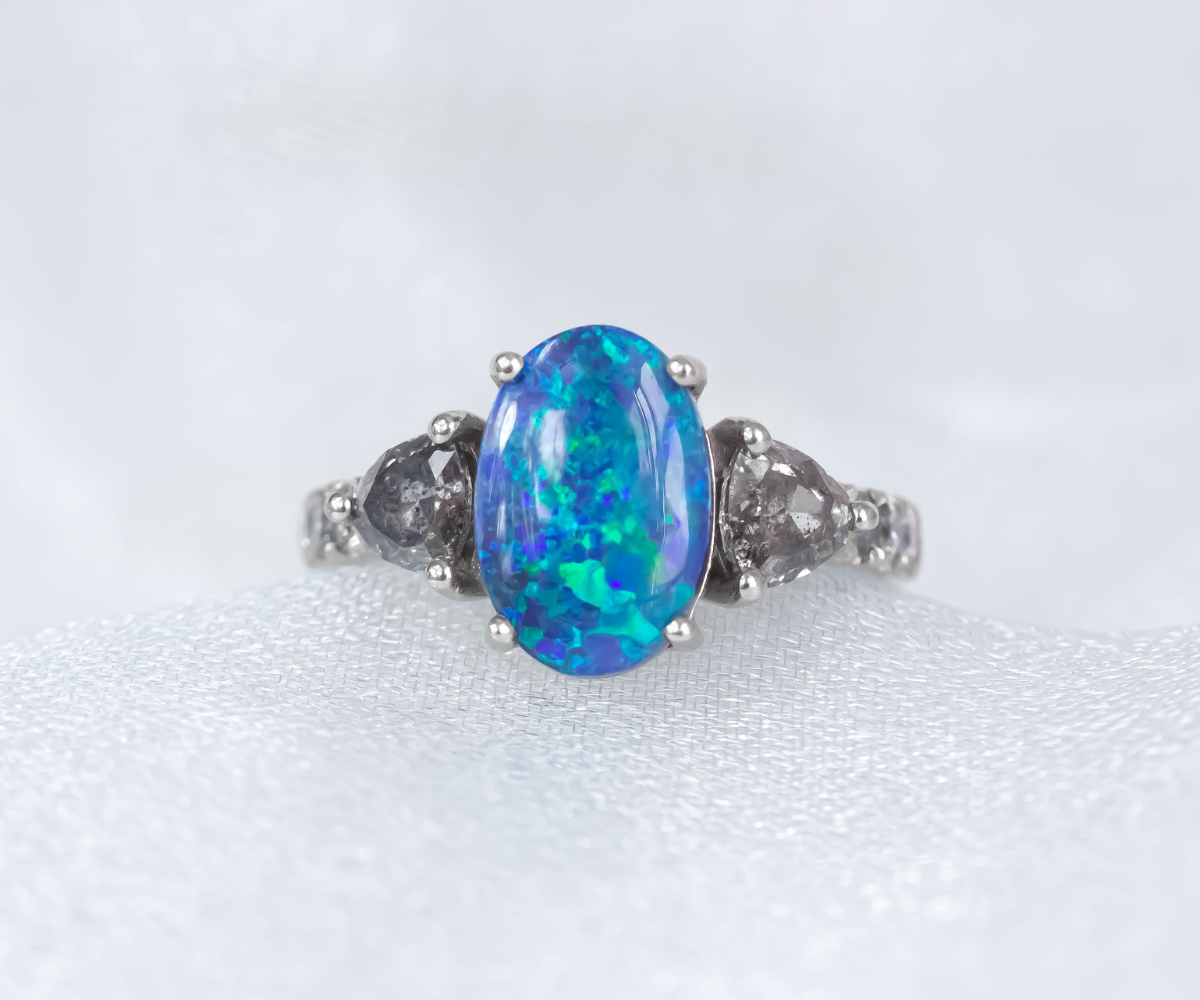 Oval Black Opal and salt and pepper diamond band engagement ring in 18K white gold