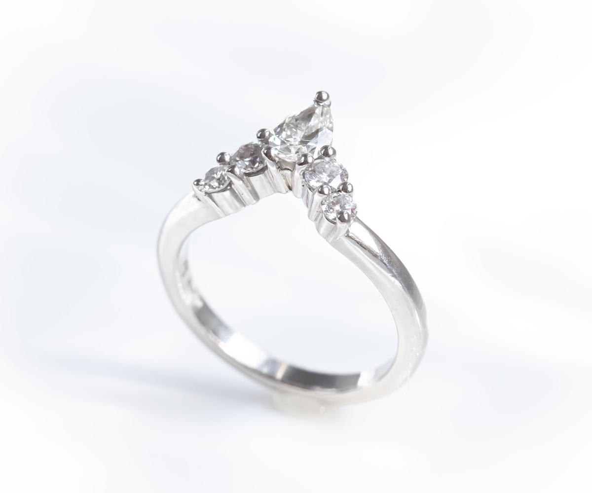 Fitted diamond wedding band with pear and round diamonds in platinum