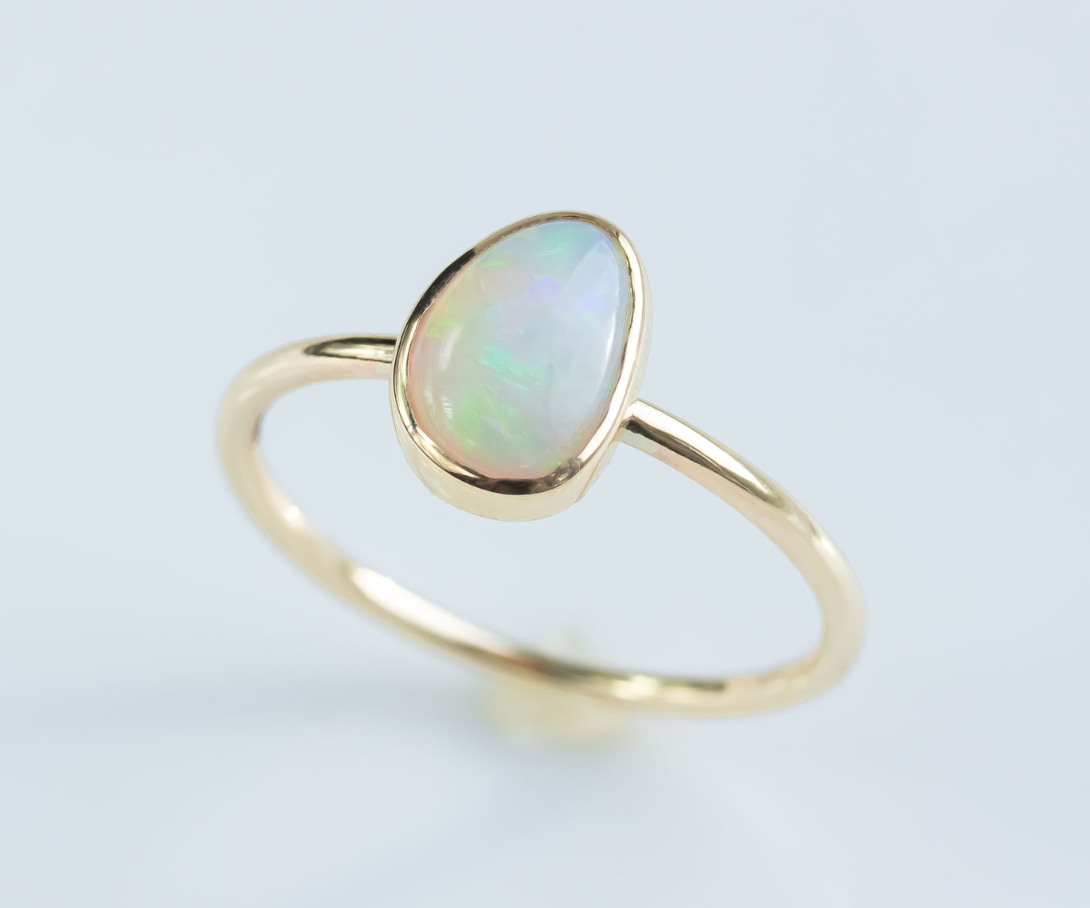 crystal opal ring bezel set in yellow gold