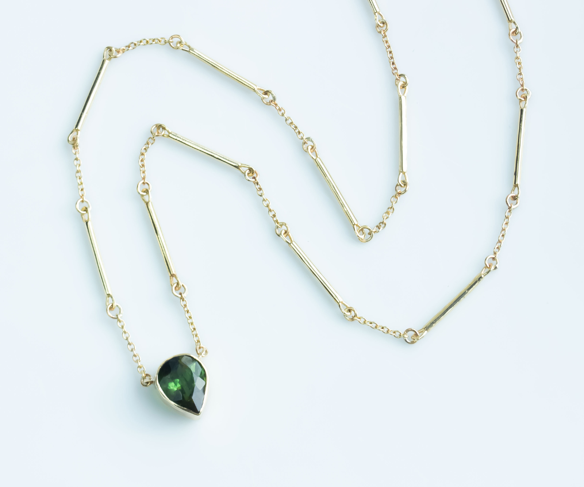 Pear green tourmaline necklace with handmade bar chain in yellow gold