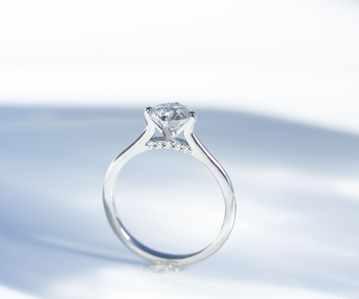 Round Diamond 1ct solitaire ring with diamond bridge in platinum engagement ring