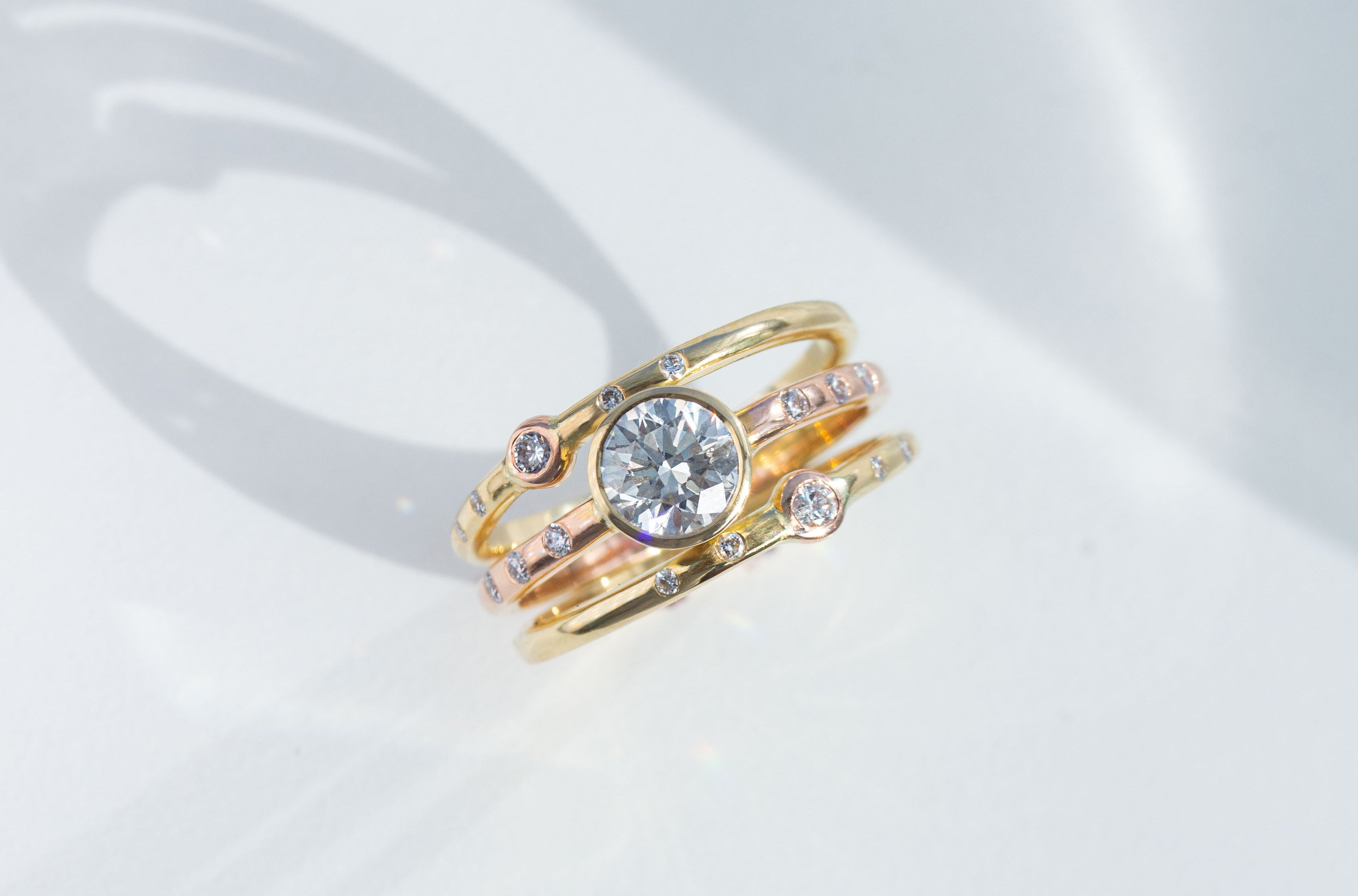 Triple Ring Design in 18K Yellow and Rose Gold and 1ct Diamond Ring Remodel on white background