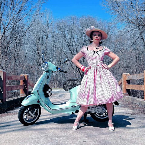 Pinup model and owner of Hollyville Boutique, Pamela Marie posing with her mint Vespa scooter on Easter Sunday.