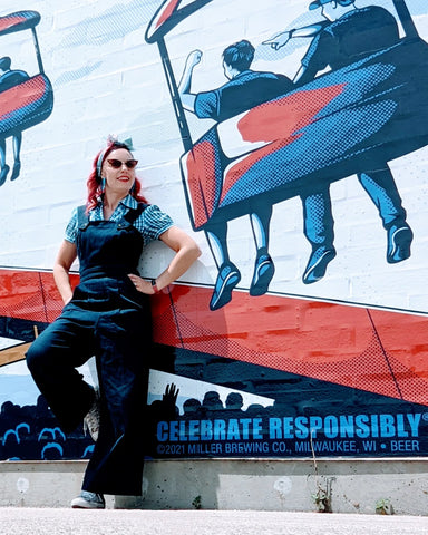 Pinup model and Hollyville owner, Pamela Marie wearing 1940's reproduction denim overalls vending at Summerfest.