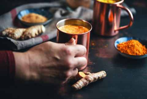 organic turmeric golden latte in a copper cup