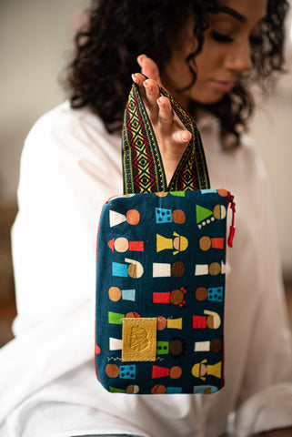 Multicultural Woman Holding Printed Wristlet