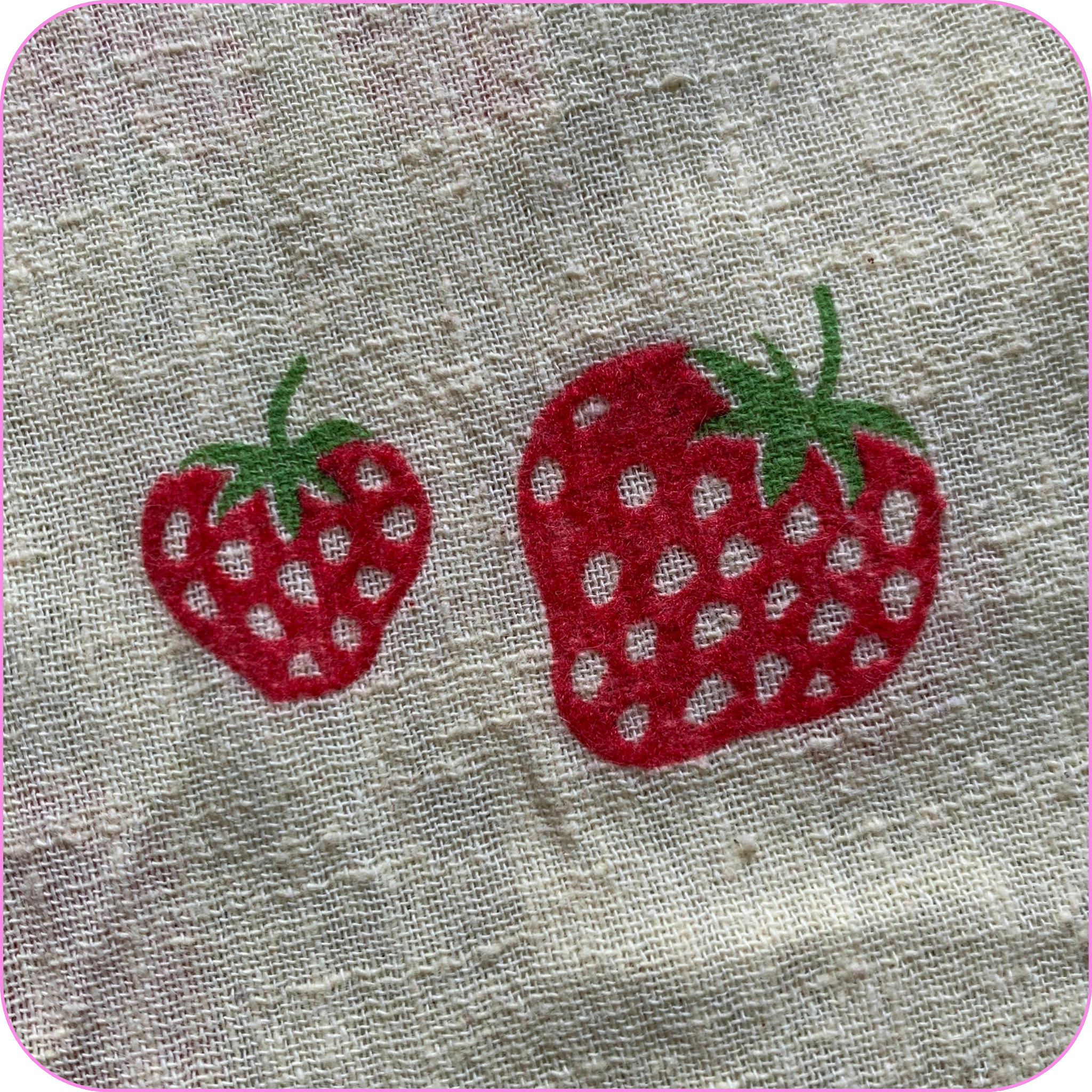 close-up of light yellow fabric with a flocked strawberry print