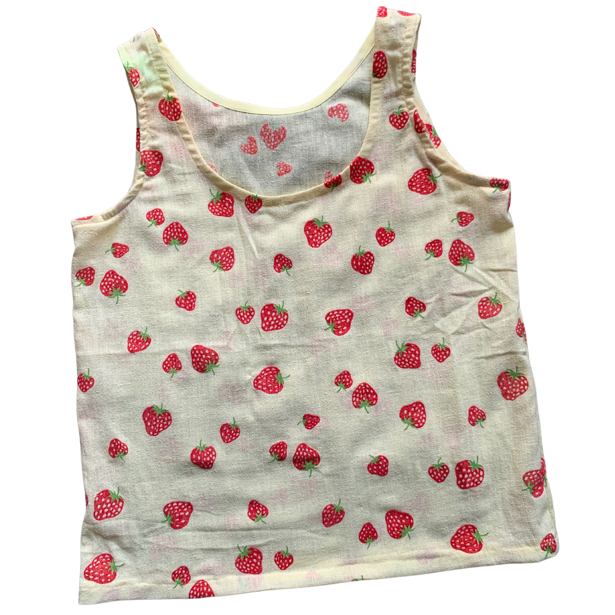 flatlay photo of a yellow tank top with strawberry print