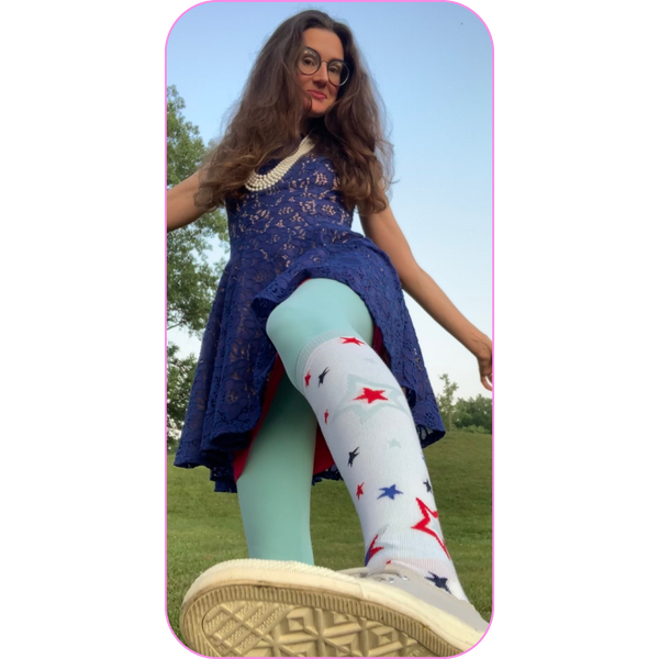 image of a woman in a 4th of July outfit, showing. close up of her patriotic knee socks