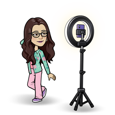 Example of Bitmoji fashion. Cartoon woman wearing a green floral jacket and pink pants, posing for a selfie in front of a tripod with ring light.